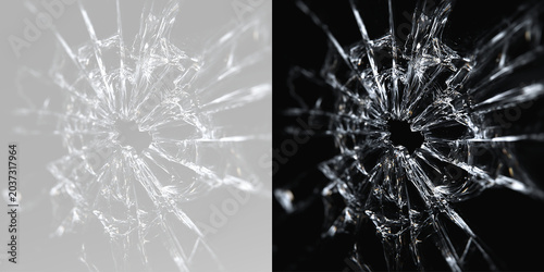 Obraz na płótnie Broken glass texture with bullet hole cracks isolated on grey and black backgrou