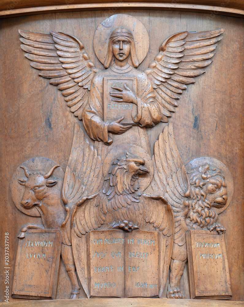 Obraz premium BERGAMO, ITALY - MARCH 18, 2026: The carved wood relief of Four Evangelist in the church Chiesa di San Leonardo by unknown artist. 