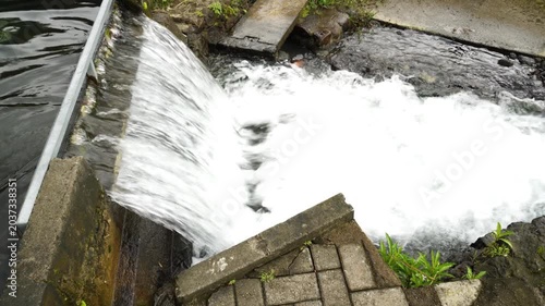 Clear water flows through irrigation canals in a village, providing clean water for rice fields. It is crucial for sustainable agriculture and efficient water management.