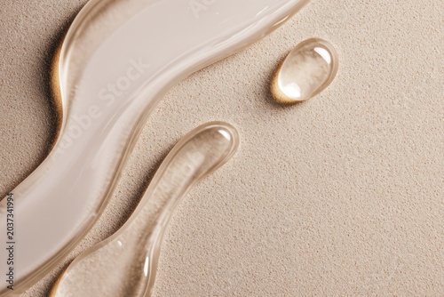Transparent cosmetic serum forming a smooth flowing curve on warm beige background. Minimal beauty concept highlighting hydration, light texture and purity.