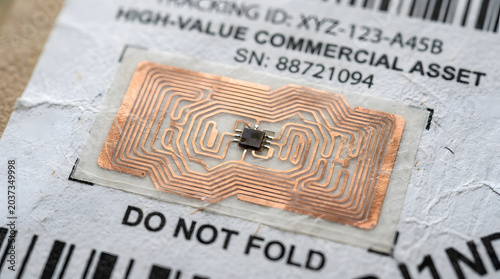 rfid tag with antenna and microchip close up photograph on shipping label