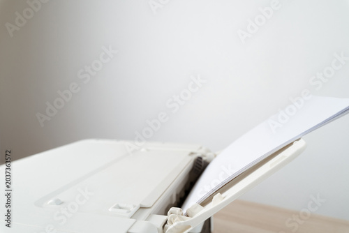White Office Printer With Blank Paper In Feeder Tray Close-Up For Document Printing And Workspace