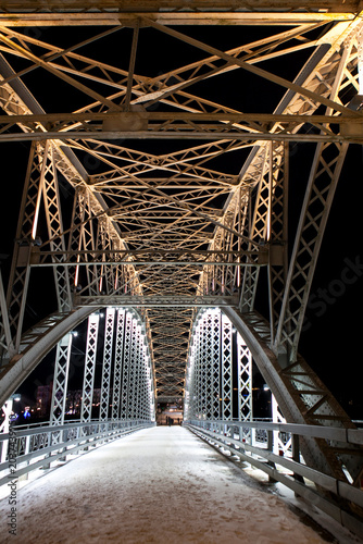 The first arch bridge built in Russia—the Belelyubsky Bridge—features architectural and artistic nighttime illumination. Borovichi, Novgorod Oblast, Russia.
