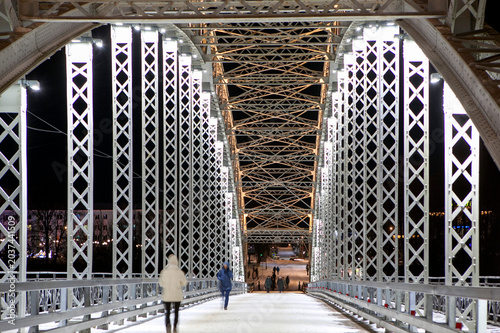 The first arch bridge built in Russia—the Belelyubsky Bridge—features architectural and artistic nighttime illumination. Borovichi, Novgorod Oblast, Russia.