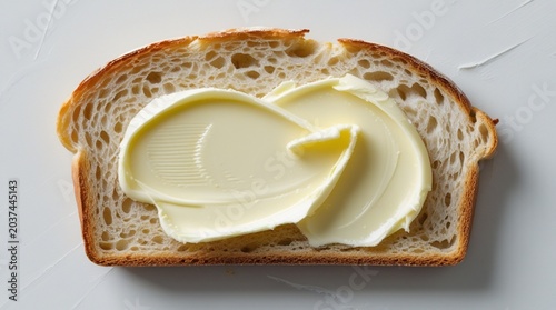 Slice of bread with creamy butter spread, simple breakfast food isolated on clean white background