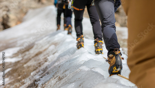 Team Of Climbers Carefully Crossing Unstable Glacial Ice Bridge