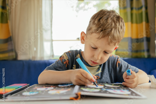 Preschooler doing exercises in a camper van in summer. 