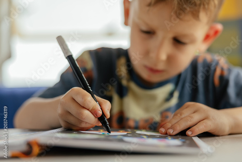 Preschooler doing exercises in a camper van in summer. 