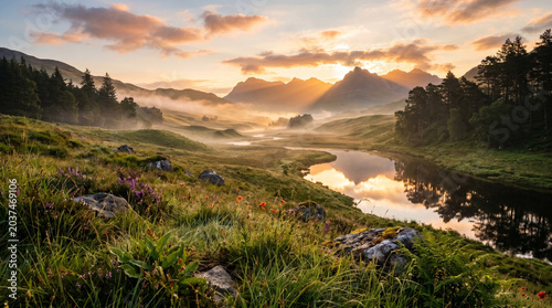 Scenic mountain valley with a winding river and misty meadows at a golden morning sunrise