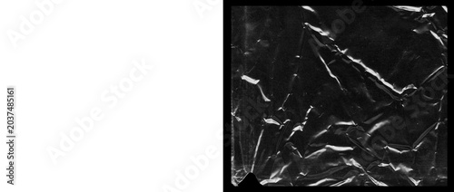 Schilderij op canvas Crumpled plastic wrap texture on black background, wrinkled transparent cellopha