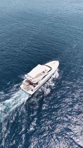 Luxury yacht cruising on deep blue ocean waters leaving white wake behind