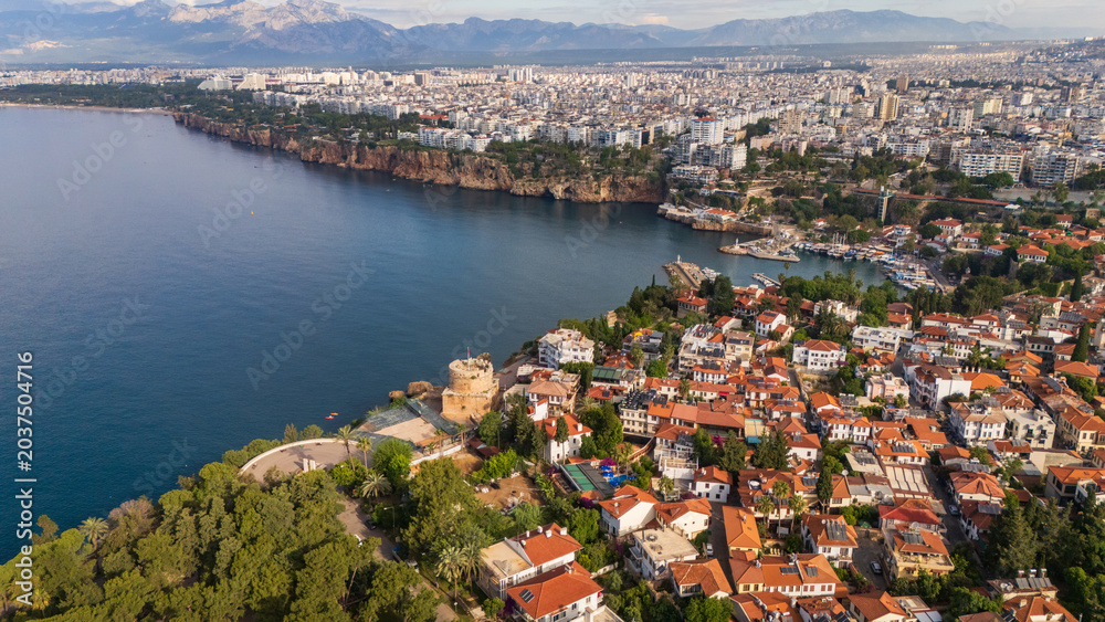 Naklejka premium drone aerial of Antalya marina harbor bay and the steep coastal cliffs. Beautiful marine landscape and Mediterranean resort town lifestyle scenery in Turkey