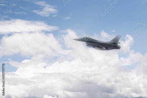Fighter jet flies through the sky on technology background
