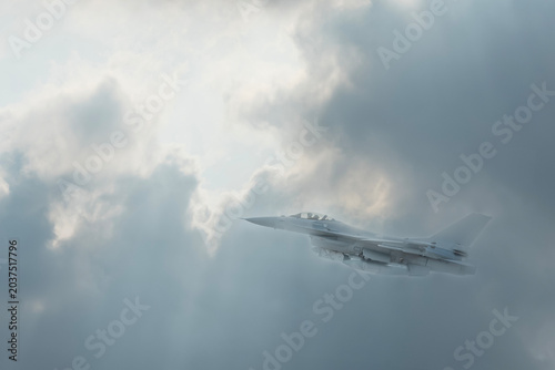 Fighter jet flies through the sky on technology background