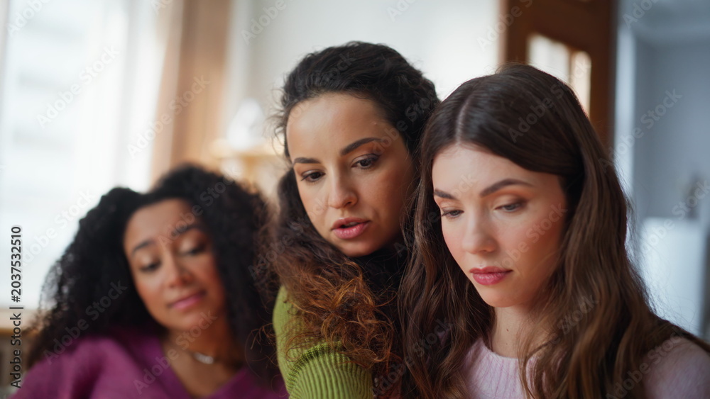 Obraz premium Group girls collaborating online project in modern apartment living room closeup