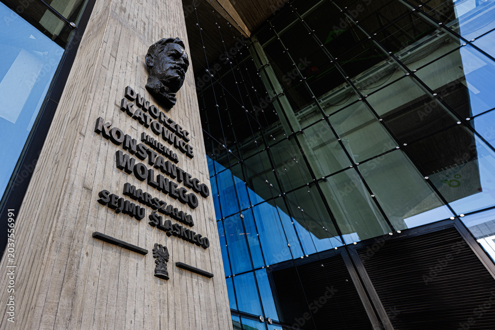 Naklejka premium Modern Katowice train station facade with commemorative plaque for Konstanty Wolny at Dworzec Katowice in Katowice, Poland glass and concrete architectural detail