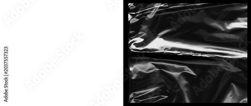 фотографія Crumpled plastic texture on black background, wrinkled cellophane wrap with high