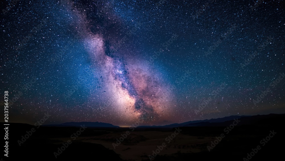 Obraz premium Breathtaking Milky Way spectacle lighting up the arid valley sky