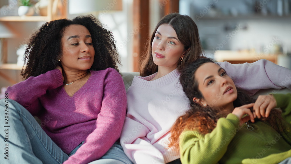 Obraz premium Peaceful friends relaxing together at cozy couch closeup. Calm women leisure