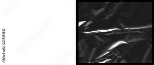 Fotografie Crumpled black plastic texture, dark wrinkled synthetic material background, glo