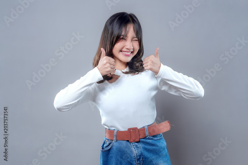 Cheerful Asian Woman Smiling with Double Thumbs Up Gesture