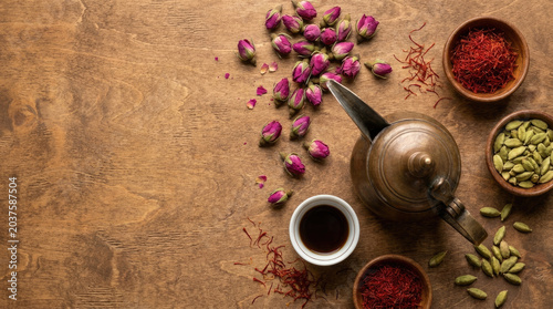 Beautiful arrangement of rosebuds, saffron, and cardamom with teapot
