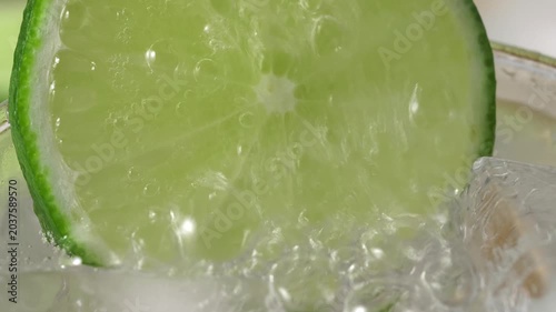 A refreshing glass of water with soda, ice and lime