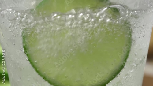 A refreshing glass of water with soda, ice and lime