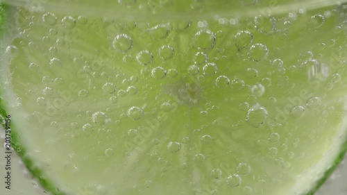 A refreshing glass of water with soda, ice and lime