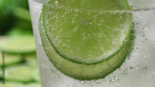 A refreshing glass of water with soda, ice and lime