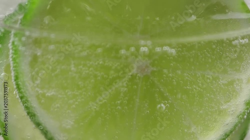 A refreshing glass of water with soda, ice and lime