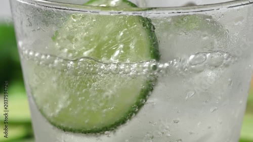 A refreshing glass of water with soda, ice and lime