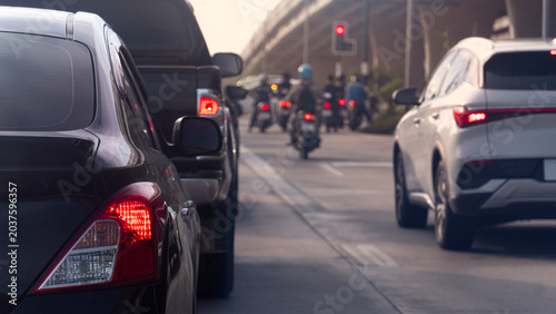Photos Abstract of black car and a white SUV move slowly through a congested urban avenue