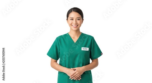 Smiling nurse in green scrubs standing with hands clasped
