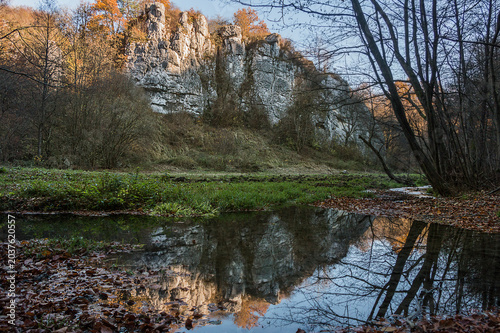Autumn landscape. Picturesque cliff and stream flowing below