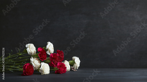 White and Red Carnations on Black Surface