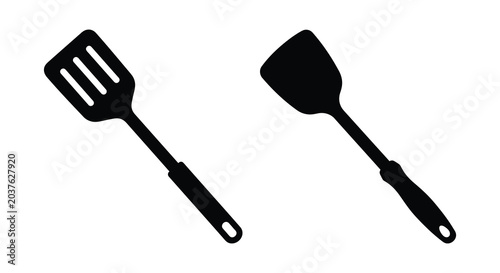 Foto Two kitchen spatulas one slotted and one solid presented as a black silhouette s