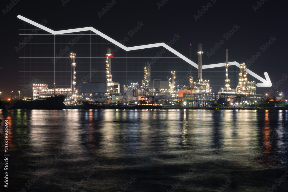 Fototapeta premium Oil refinery plant in Bangkok, Thailand, illuminated at night reflected across water. Downward-trending financial graph overlay, Highlight falling oil prices and declining market demand.