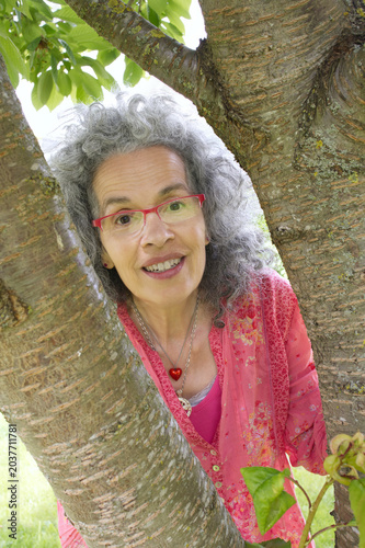 Curious neighbor woman near tree