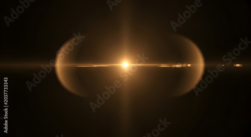 Golden lens flare with bright starburst effect on black background dramatic lighting