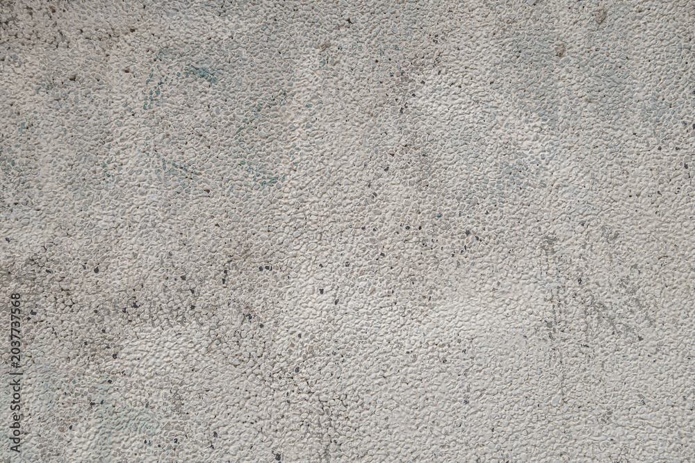 Fototapeta premium Close-up of rough painted concrete or stucco wall texture with small granular details. Neutral gray surface background suitable for construction, architecture, industrial, design projects.