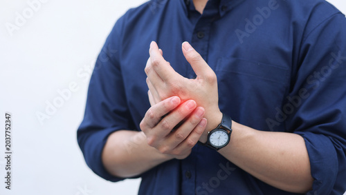 close up employee man massage on his hand and arm for relief pain from hard working ,carpal tunnel syndrome concept