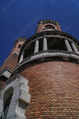 old tower symbol of the city made of red facade brick photographed on a sunny day