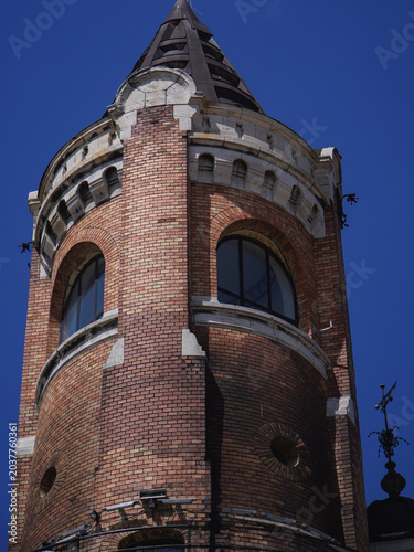 old tower symbol of the city made of red facade brick photographed on a sunny day