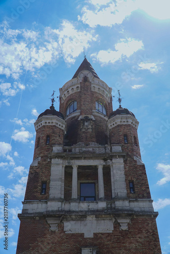 old tower symbol of the city made of red facade brick photographed on a sunny day
