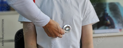 Young patient being examined with a stethoscope in a medical office during a routine checkup