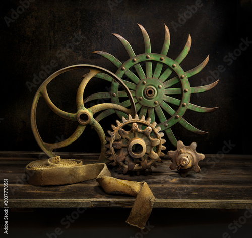 Fotografie Still life of vintage wheels, gears, and belt from old farm machinery, circa 1900