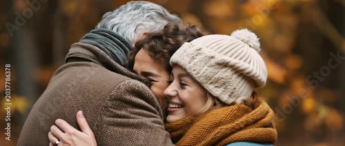 Family members share laughter and warmth in a cozy autumn setting during a fun gathering in the park