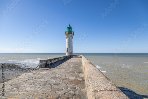 Historic White and Green Lighthouse on a Stone Pier