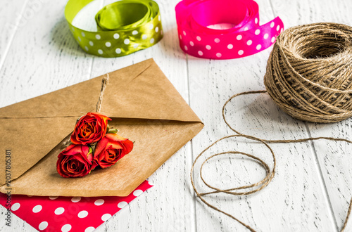 envelope and flowers on wooden background mock up